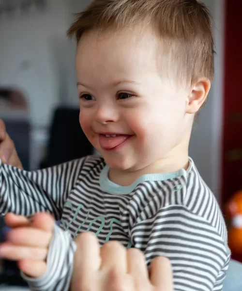 Cute boy with Down syndrome playing 600h